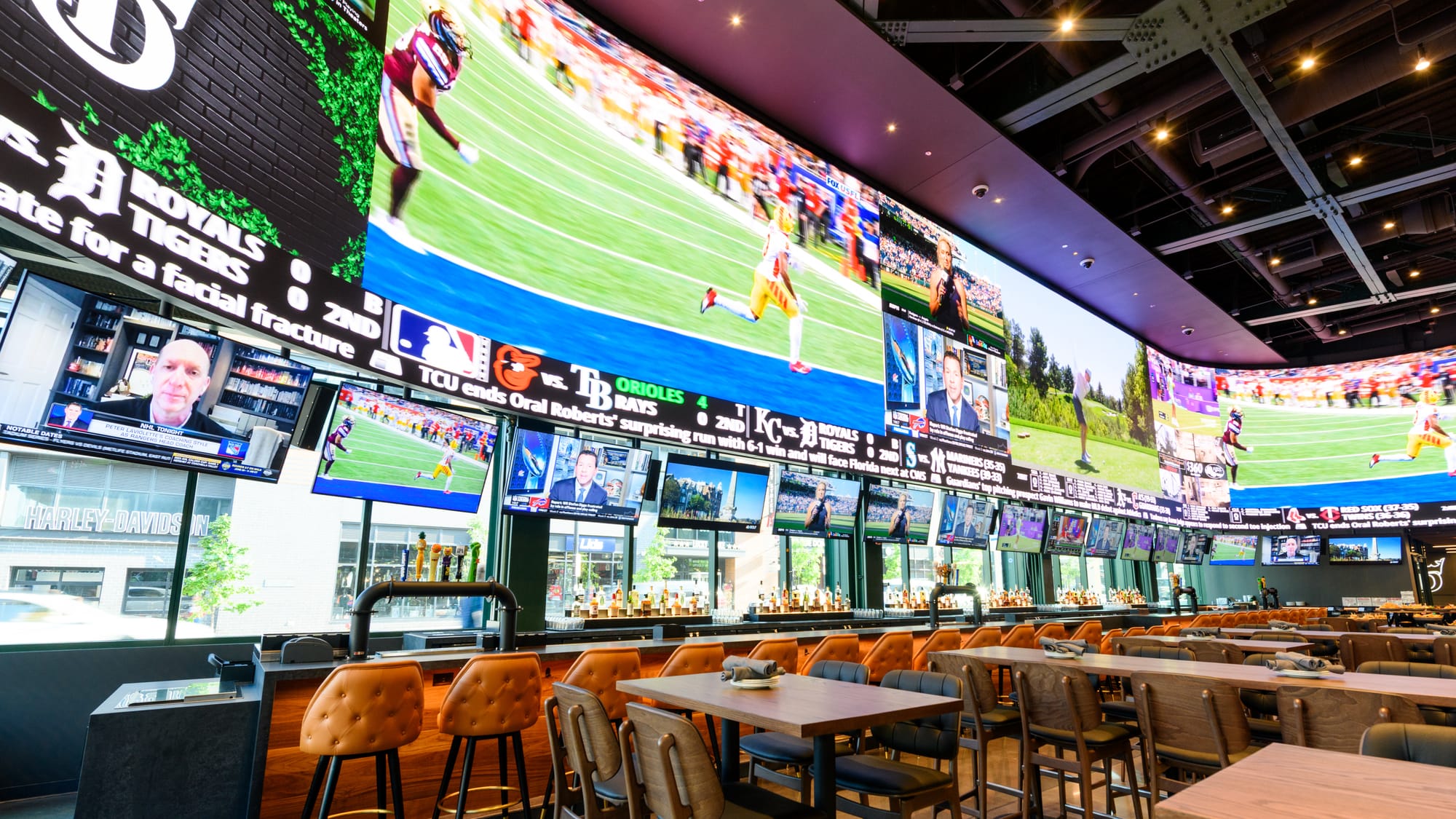 A bar with a giant video wall and several TVs.