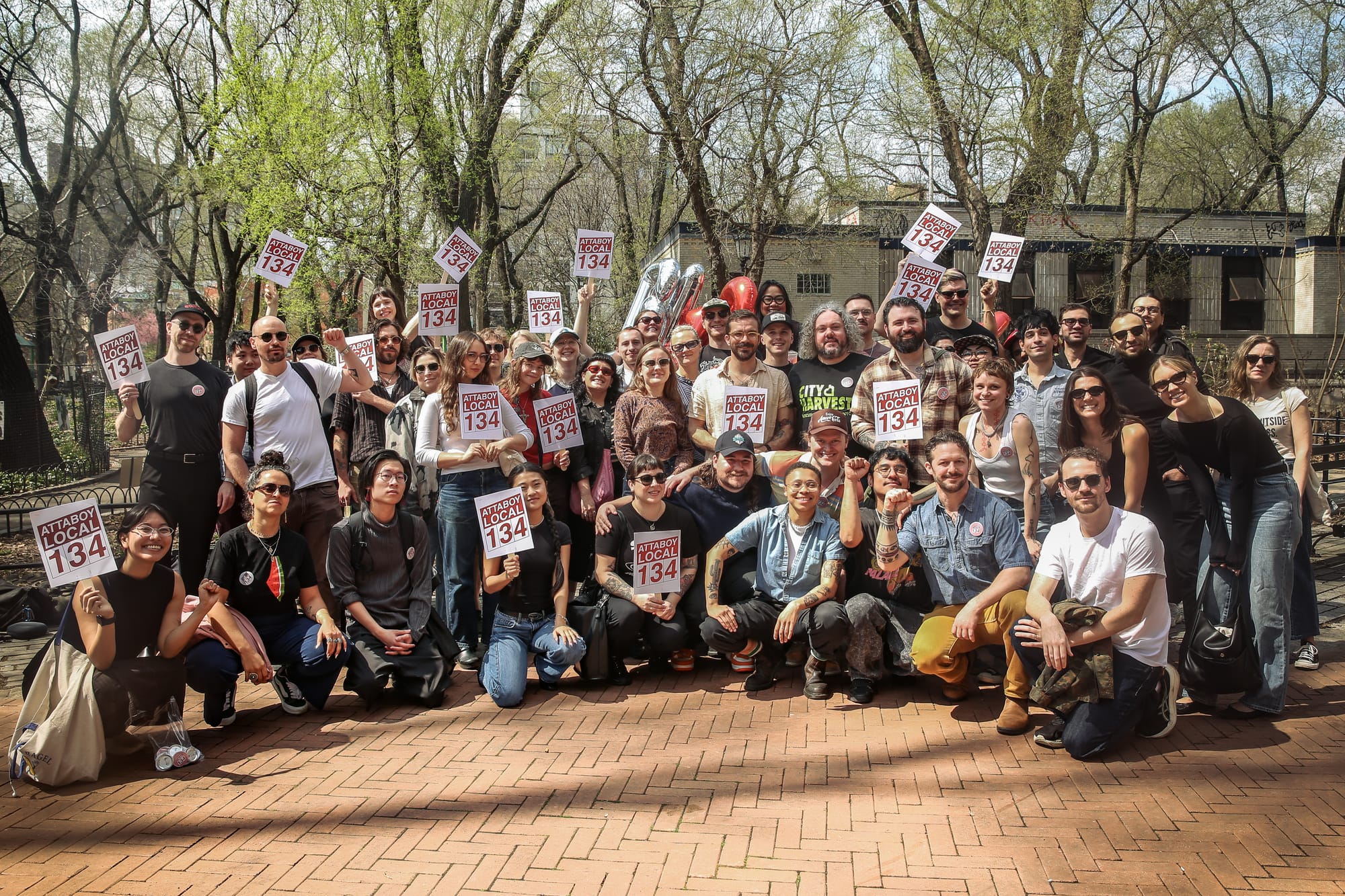 A group of workers holding Attaboy Local 134 signs