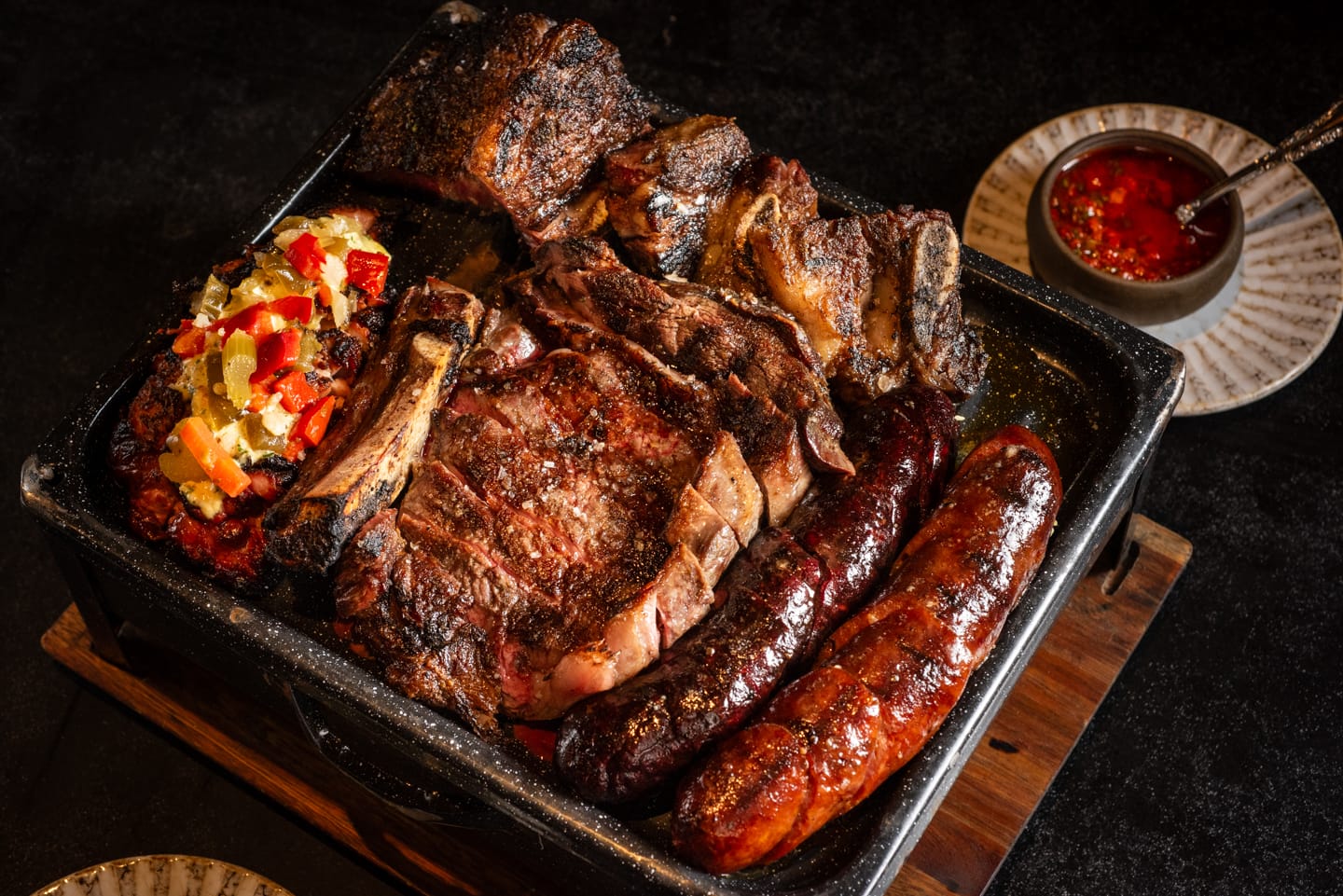 A metal platter filled with meats.