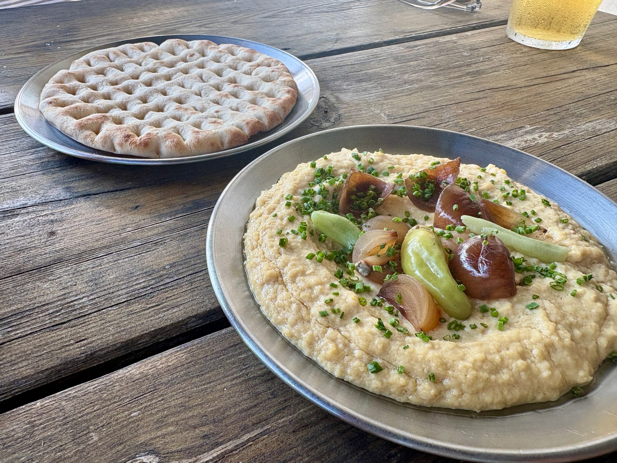 To the back left is a flatbread. Right front is cauliflower and white bean hummus.