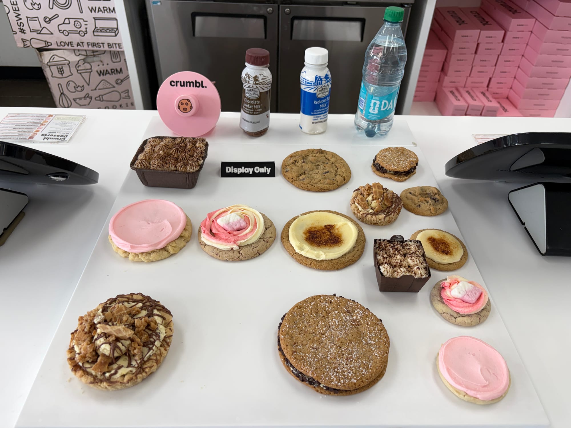A display of various cookies on the counter at a Crumbl shop in Dallas.