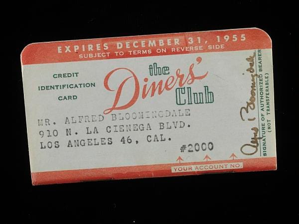 A red and white card reading the Diners' Club, property of Alfred Bloomingdale