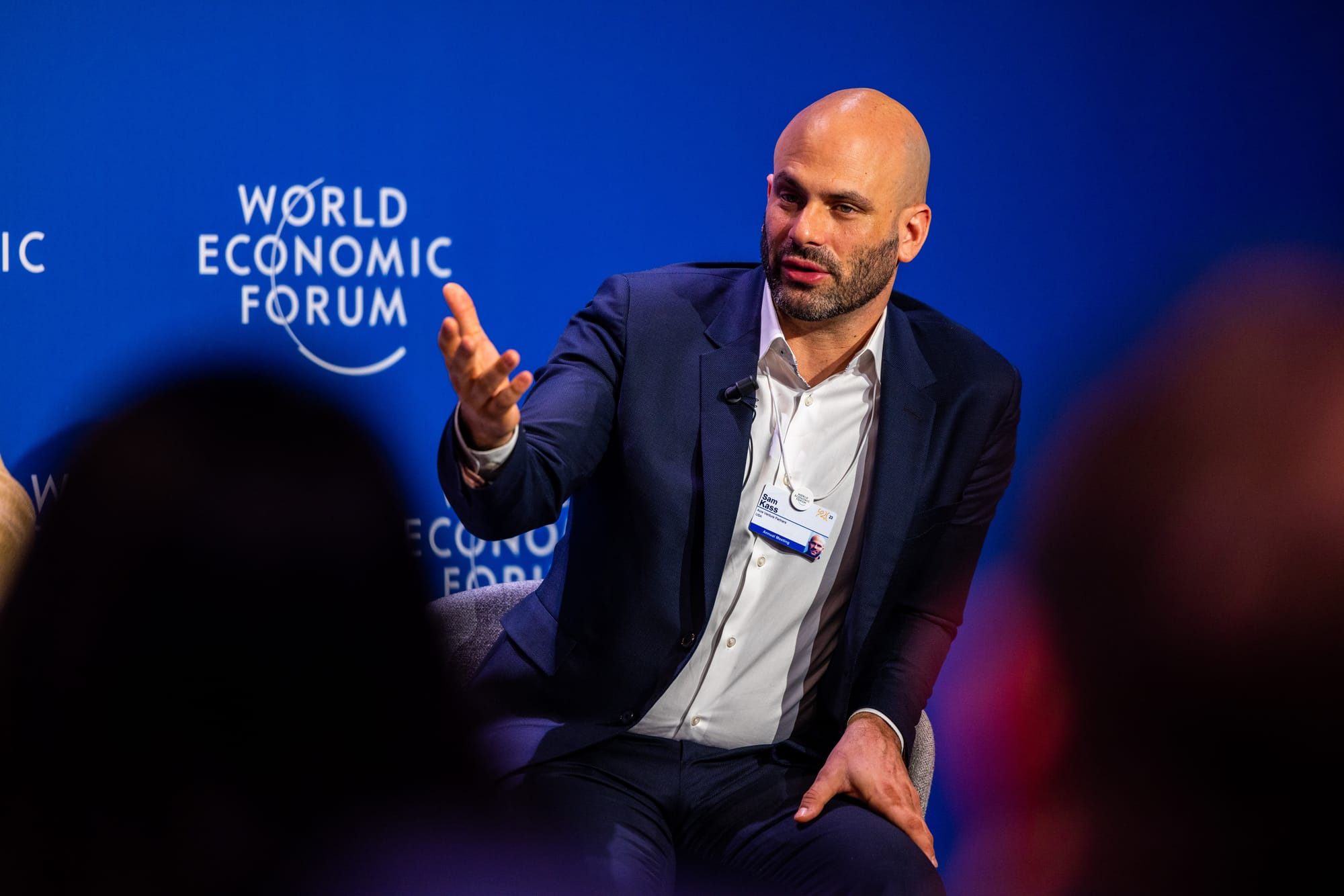 Sam Kass dressed in a sport coat and seated at the World Economic Forum.