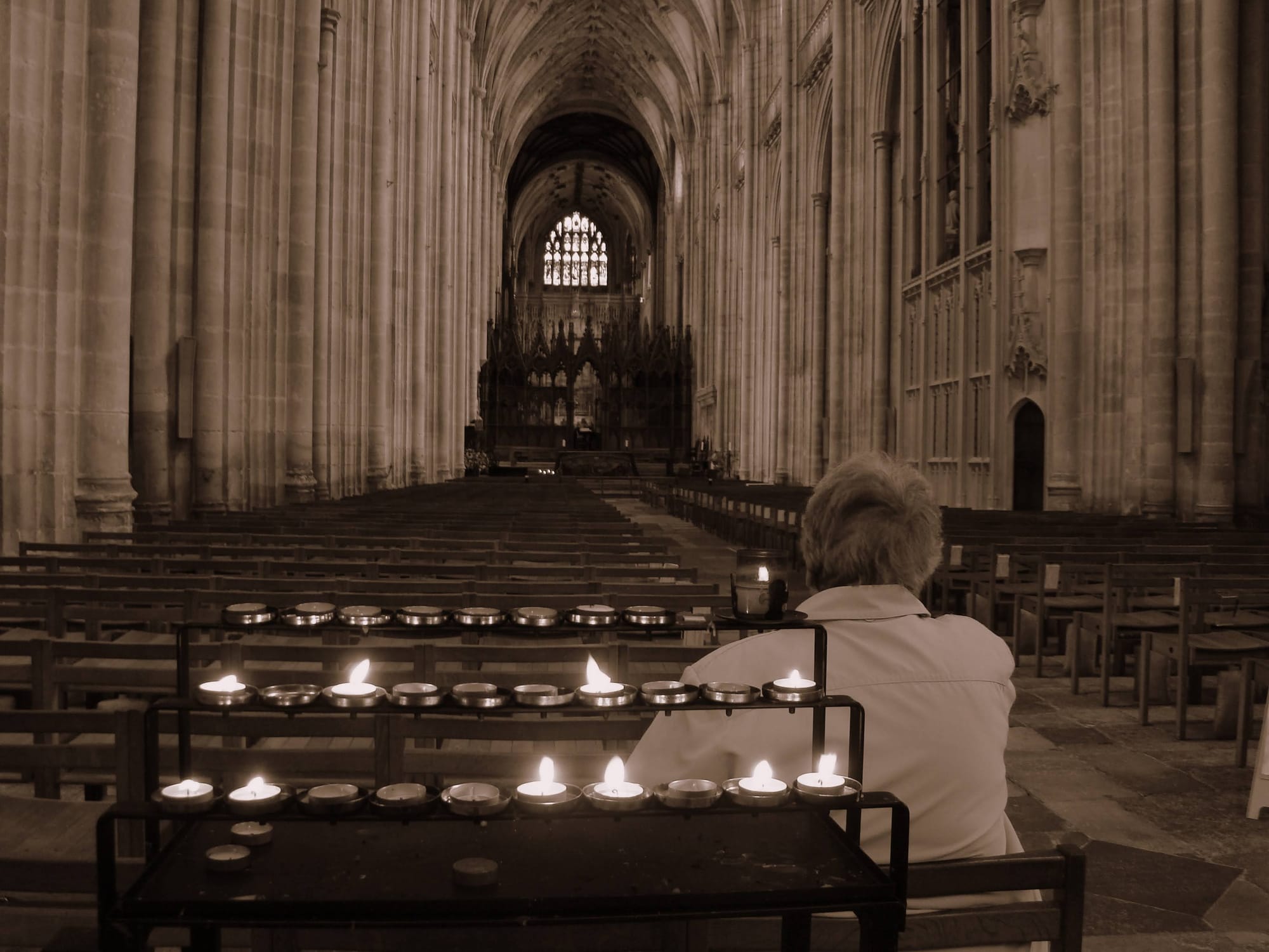 A woman sitting inside Winchester Cathedral