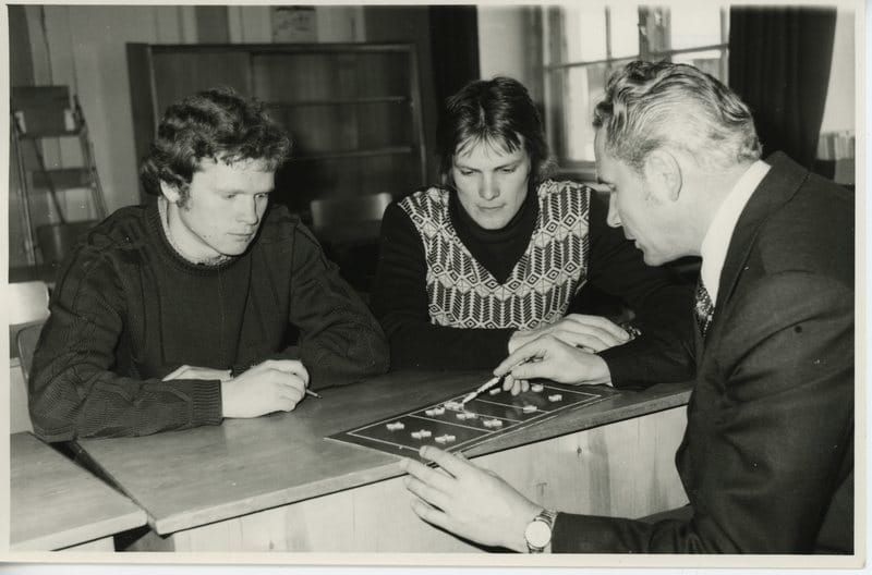 An old photo of a sports coach with players - from : Võrkpallitreener Vello Truumaa õpilastega - Estonian Sports and Olympic Museum, Estonia - CC0.