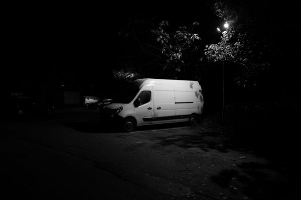 A photo of a white van parked under a light in Birmingham