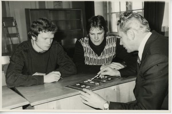 An old photo of a sports coach with players - from : Võrkpallitreener Vello Truumaa õpilastega - Estonian Sports and Olympic Museum, Estonia - CC0.