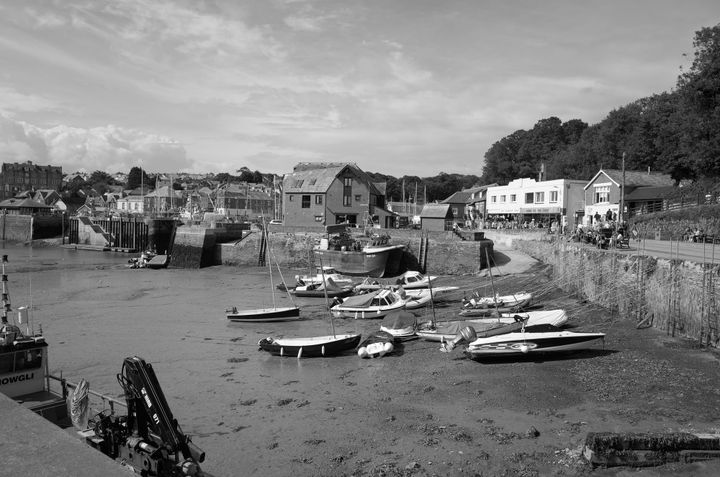 A calming photo of a Cornish harbour with boats moored