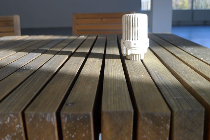 A photo of a radiator valve on a table