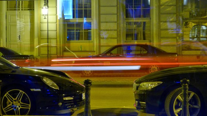 A photo of a fast car passing a window