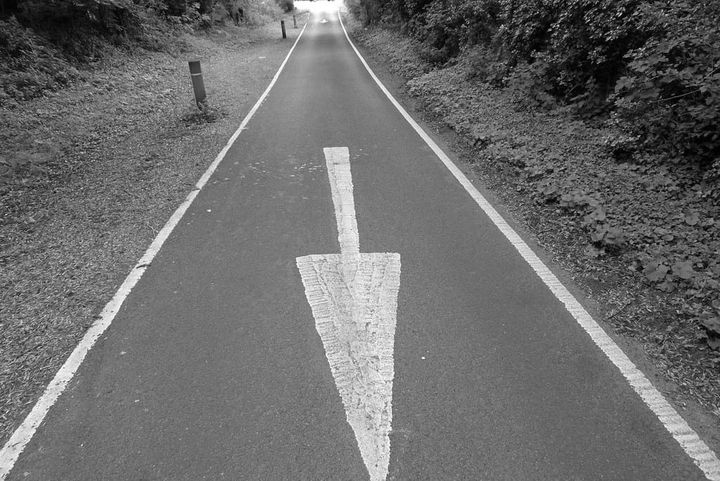 A photo of an arrow on a road