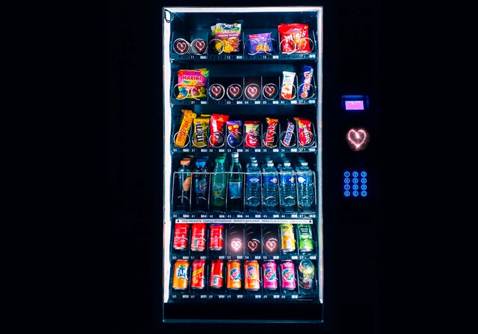 A photo of a Vending Machine with a heart under the payment pad