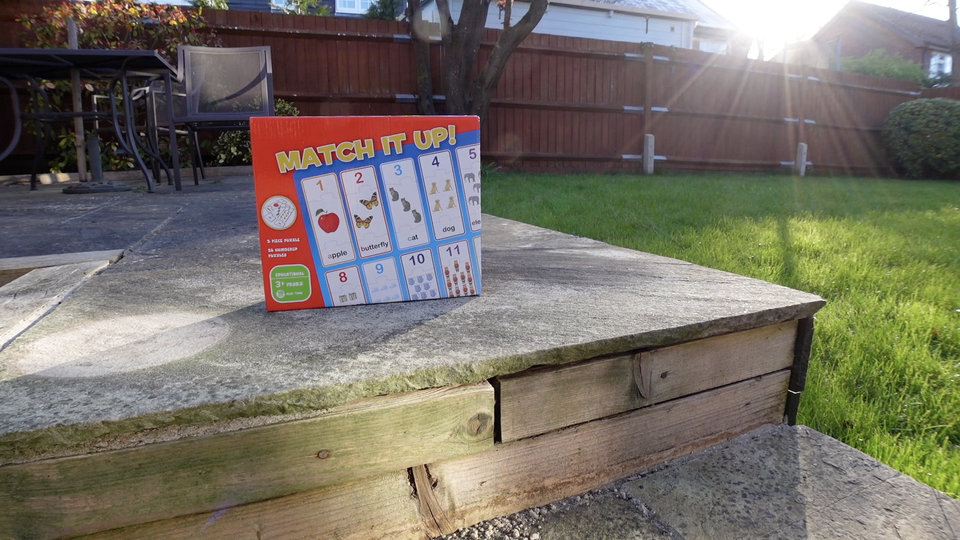 A photo of a children's puzzle on a step in sunlight