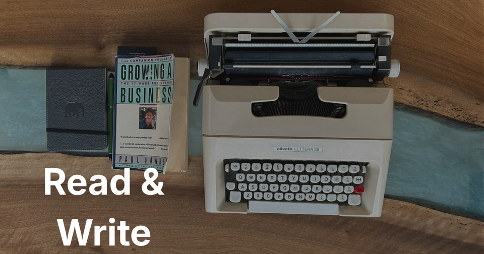 A photo of a type writer on a desk with some books - text overlaid - Read & Write