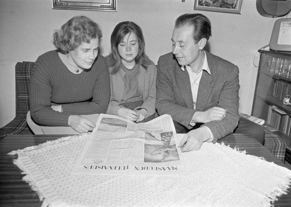 A photo of a family sat reading the paper - Maaseudun Tulevaisuus newspaper is being read by Voutilainen, Erkki - Finnish Heritage Agency, Finland - CC BY.