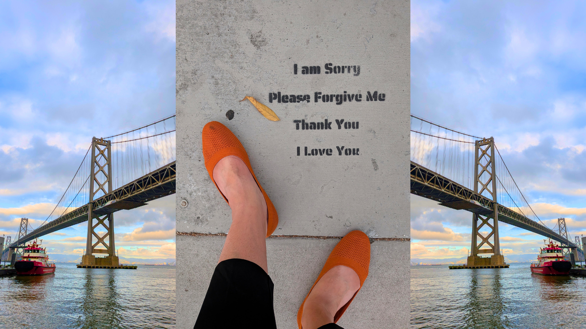 Street text on a sidewalk flanked by images of the bridge into East Bay.