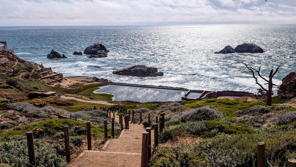 Looking down the stairs at the "Roman Bathhouse" in San Francisco over the water.