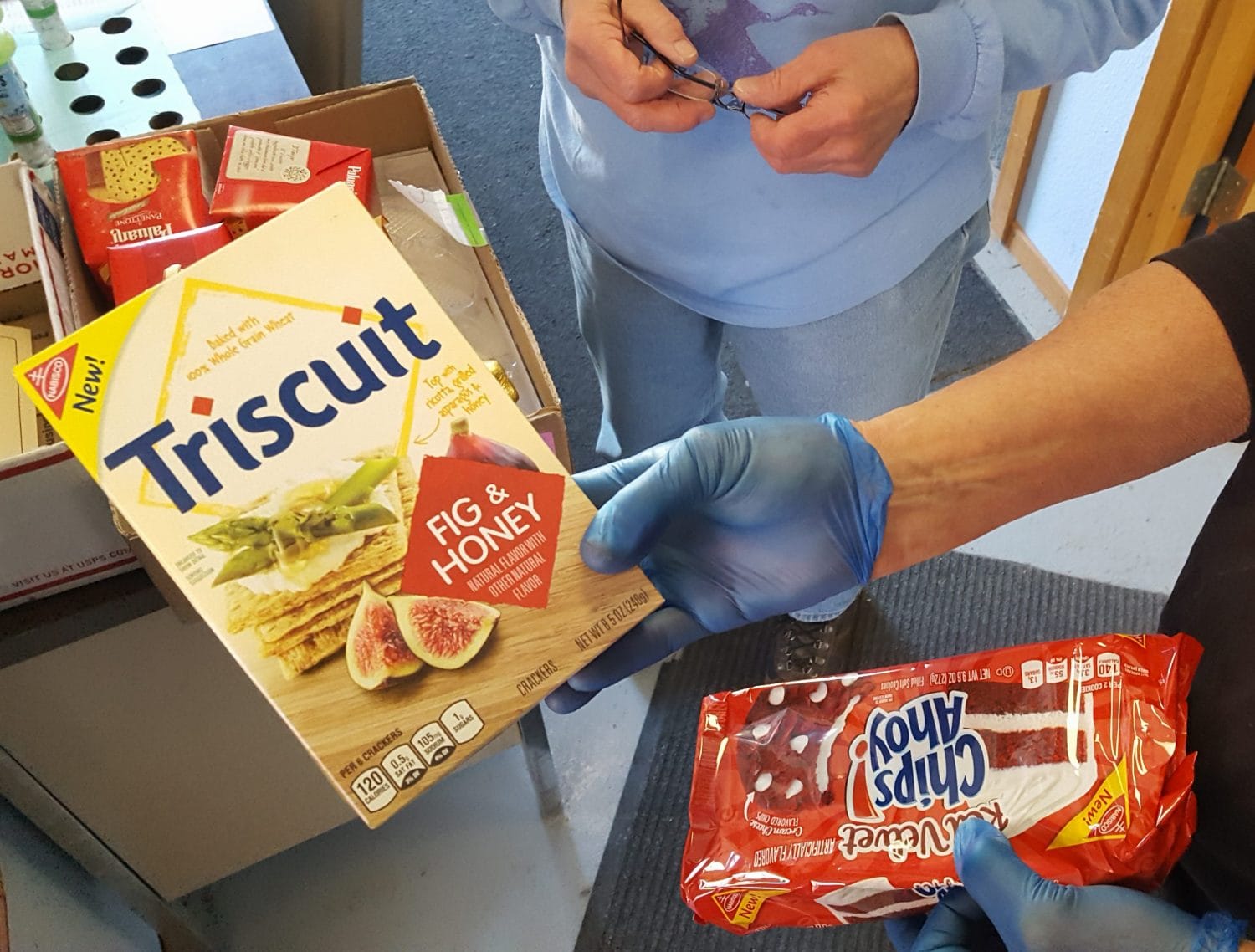 Sometimes, the food pantry receives uncommon varieties of well-known products, as shown by volunteer Doug Smith.  Photo: Phillip Manning - KTNA