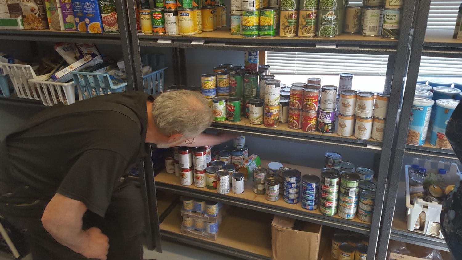 Keeping up with demand involves constant effort.  Here, volunteer Ron Caldwell assesses what might be needed later in the day.  Photo:  Phillip Manning - KTNA