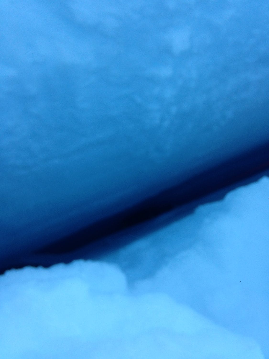 View from the top of the crevasse, with Martin Takac and a rescuer inside, but not visible from the surface. NPS Photo/Frank Preston