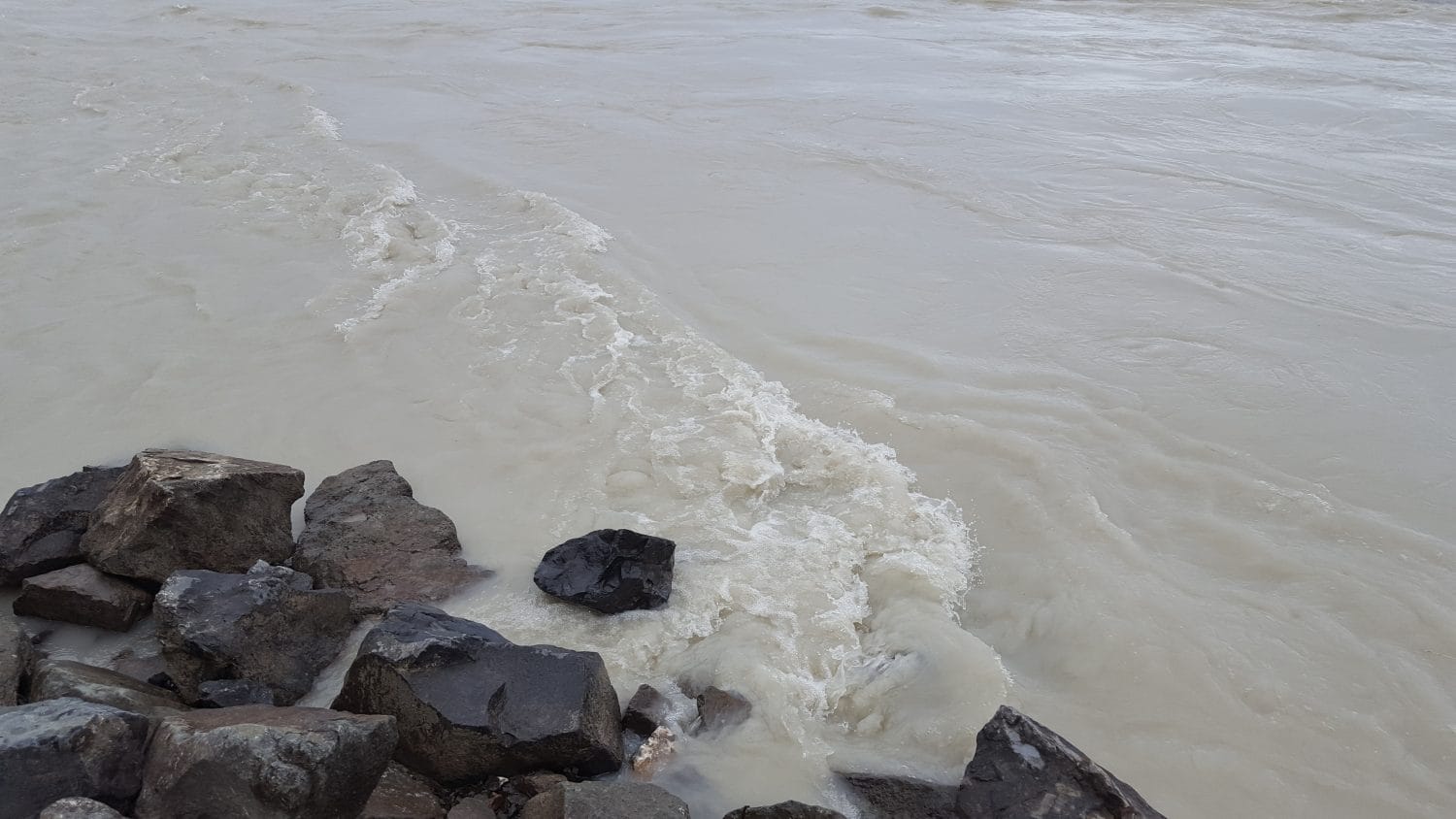 Water rushes against the shoreline near where the Talkeetna and Susitna Rivers meet.  Photo:  Phillip Manning - KTNA