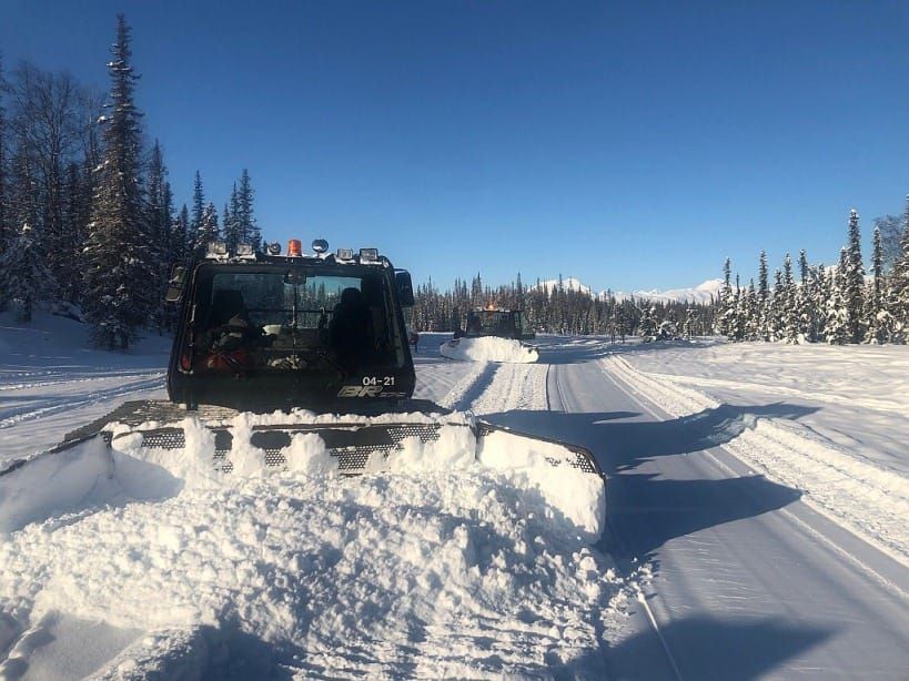 Two Snowcats groom motorized vehicle trails