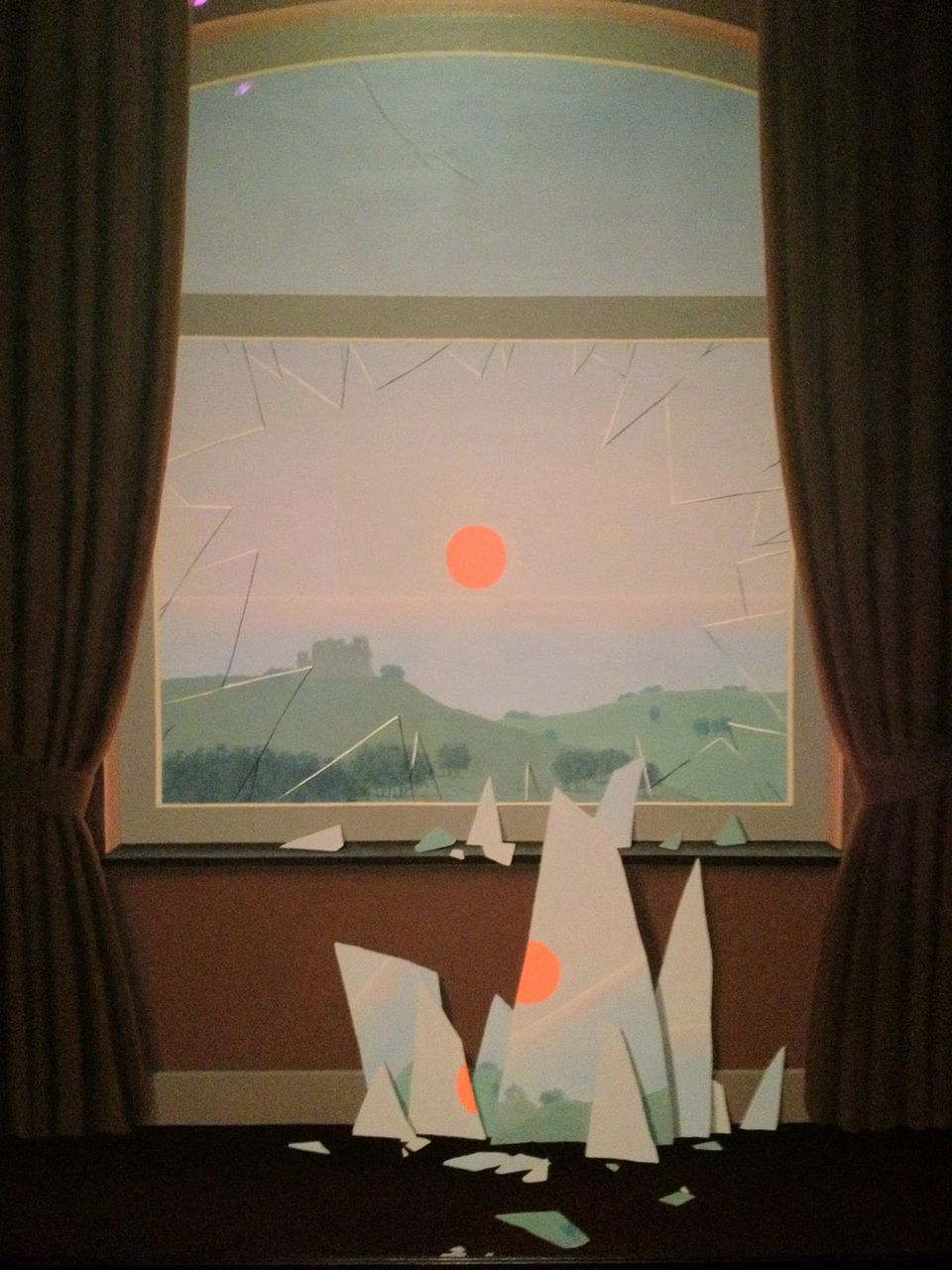 René Magritte’s “Evening Falls” from 1964 shows a broken window with the image still reflected on the shards.
