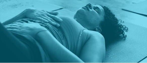 this body laying on the floor, hands on torso, tinted blue