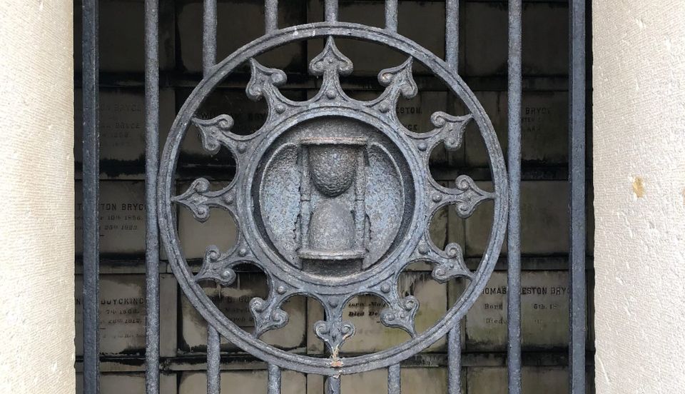 Crypt detail: iron gate winged hourglass-- time flies