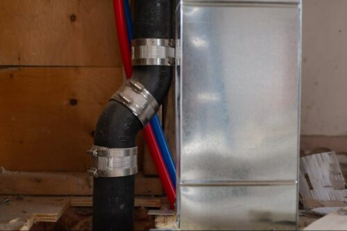 Construction view of plumbing and HVAC setup.