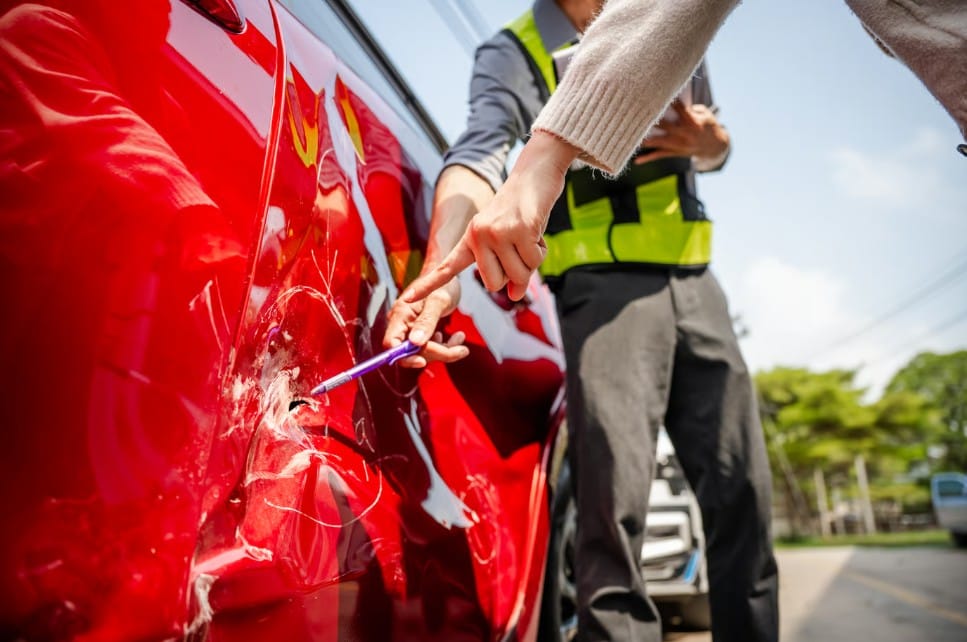 Assessing vehicle damage and filing an auto accident insurance claim.