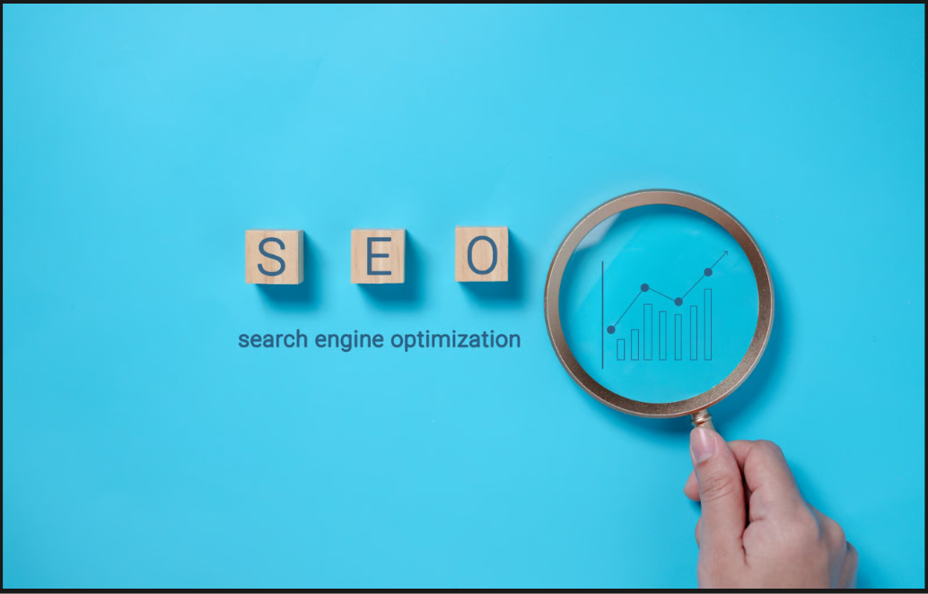 Wooden letter blocks spelling "SEO" next to a hand holding a magnifying glass over a growth chart graphic on a blue background.