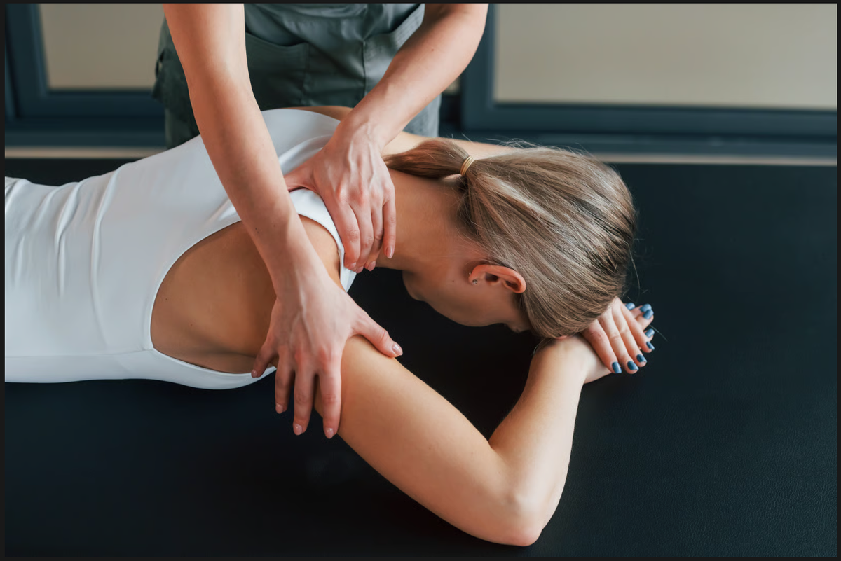 Woman receiving upper back therapy during a chiropractic services session for posture and joint relief.