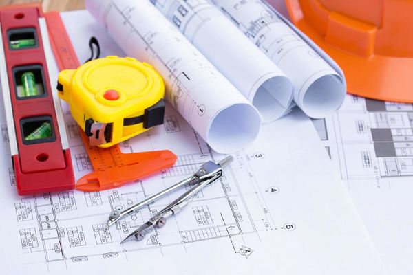 Architect reviewing remodel plan to avoid change orders.