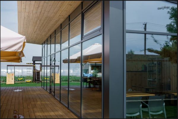 Commercial property exterior featuring protective security window film on large glass facade panels.