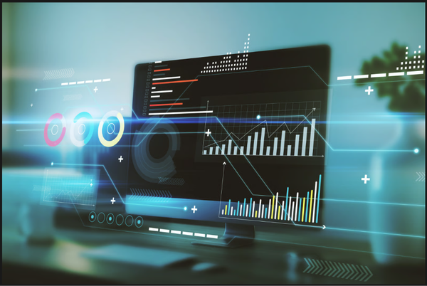 Computer screen displaying futuristic glowing data charts, bar graphs, and analytics overlays on a blurred office background.