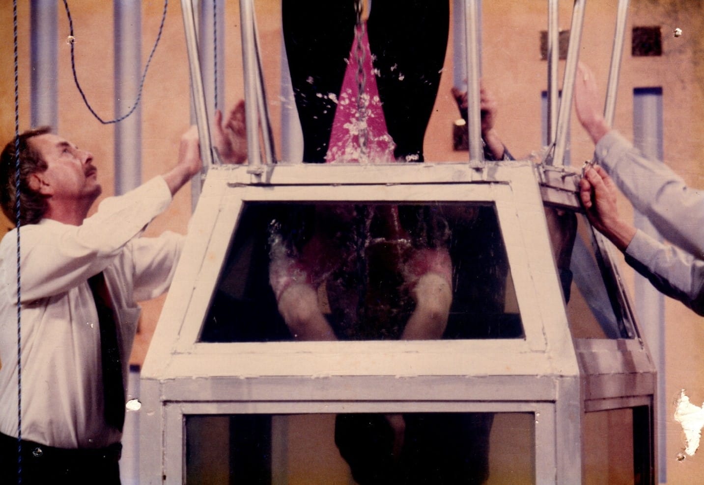 Helen Coghlan performs her father's version of Houdini's famous Water Torture Cell. Here she's pushed into the water, head first, before it's locked shut.