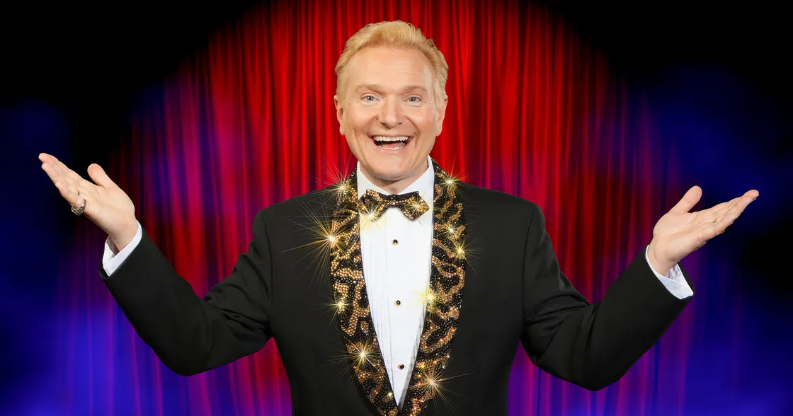 Photo of Jeff Hobson in front of a red curtain