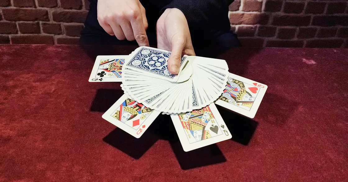 A deck of playing cards fanned out with Queens sticking out