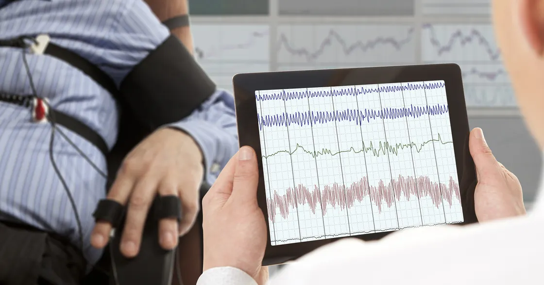 Person holding a tablet giving lie detector test