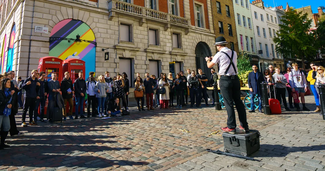 Street magic performer in front of a crowd in Covent Garden