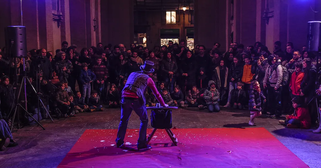 Street magician performing in front of a crowd