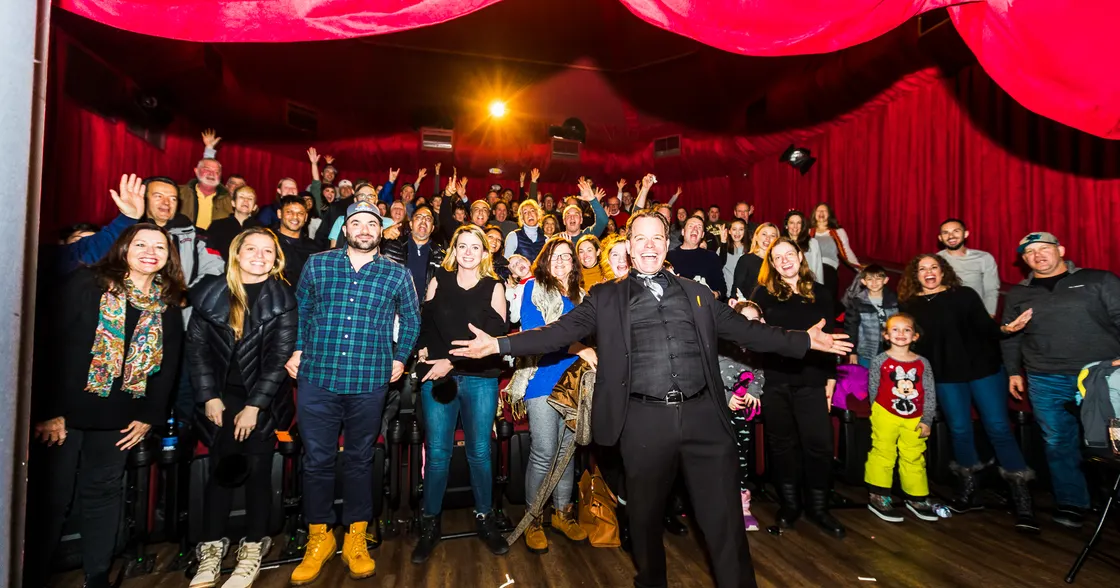 Magician Matt Marcy in front of a happy crowd