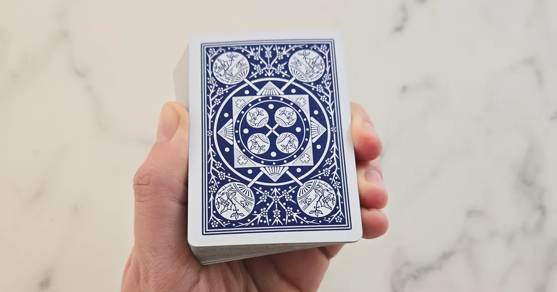 Hand holding a deck of playing cards