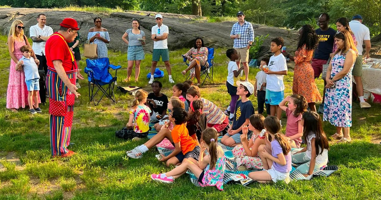 David Kaye performing in front of kids and parents at a park