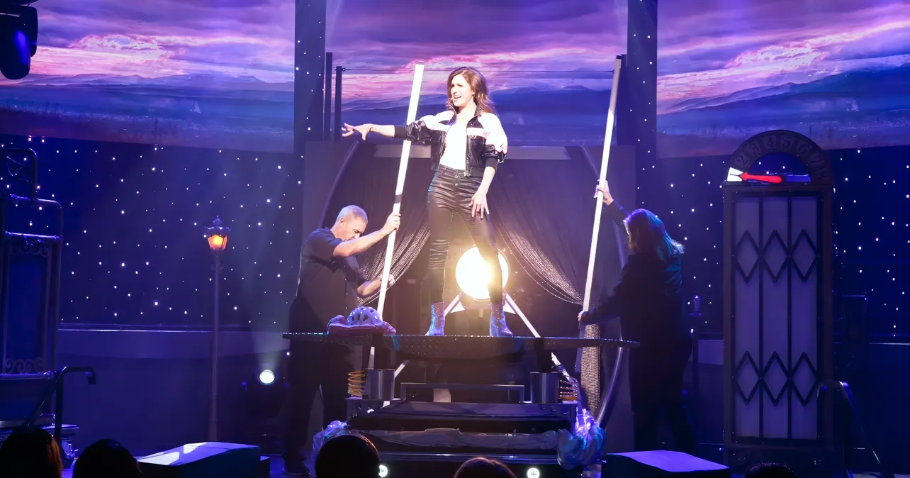 Jen Kramer on stage performing magic