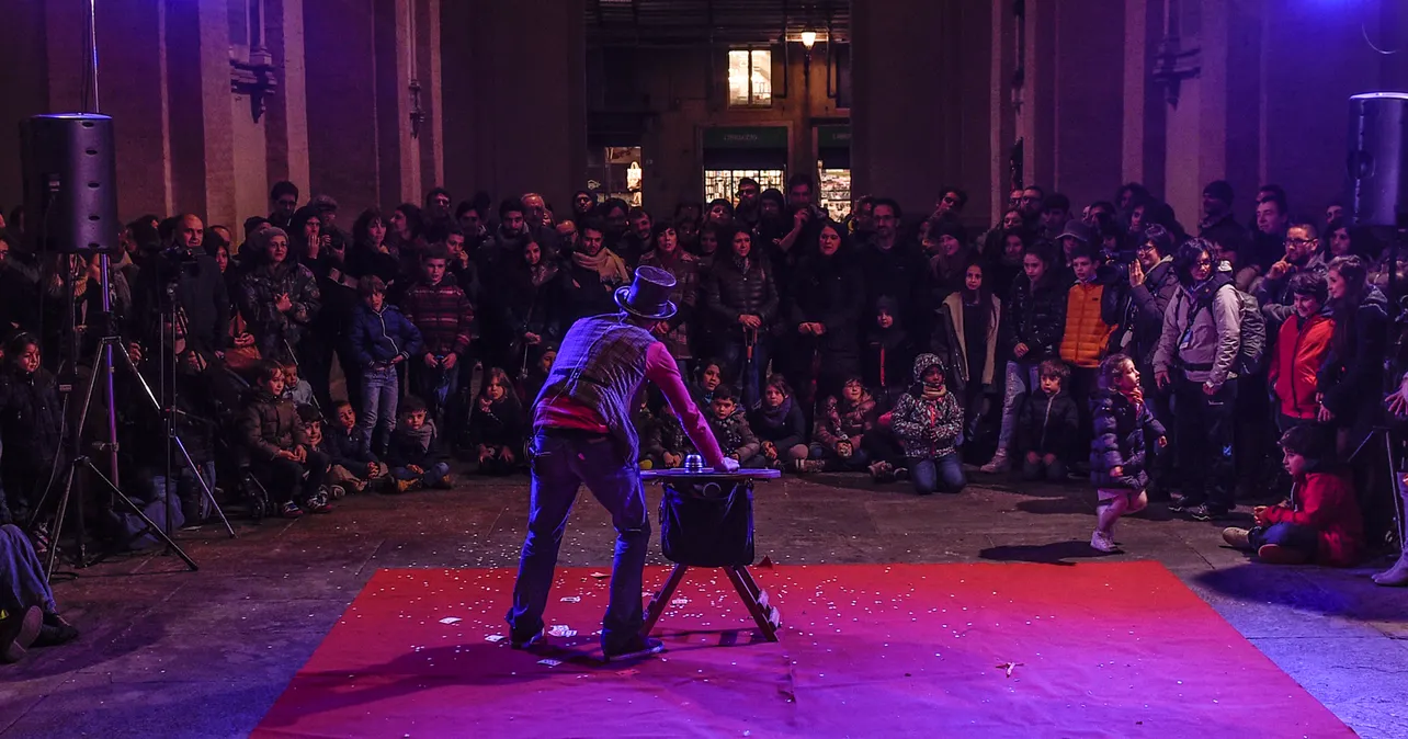 Street magician performing in front of a crowd