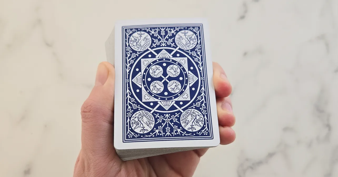 Hand holding a deck of playing cards