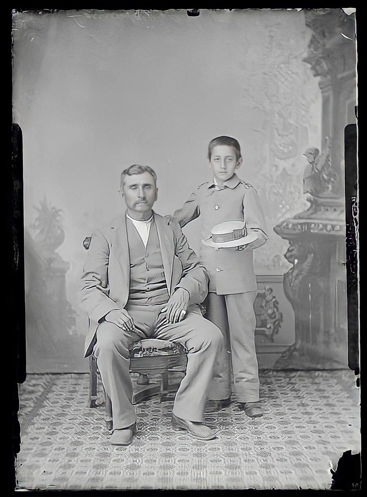 Baptiste Bayhylle and his son, Louis Bayhylle, at the Carlisle Indian School. Louis wears his school uniform.