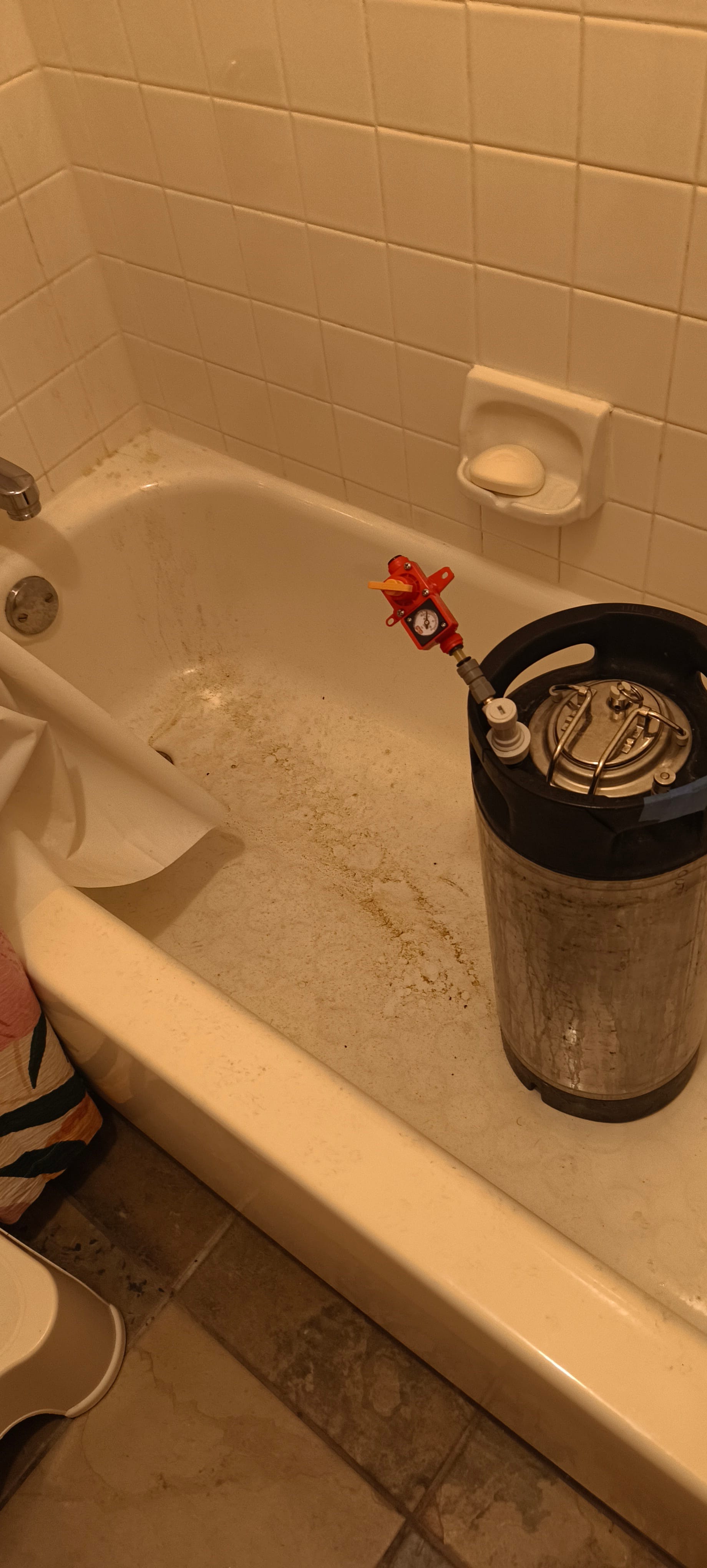 The keg in my bathtub, with a spunding valve on the gas post. The spunding valve allows for a controlled pressure environment to be maintained and will only vent if the pressure exceeds the setting. When mine did, it spewed hop-filled foam all over the tub the keg is sitting in and the wall, which can be seen as greenish residue
